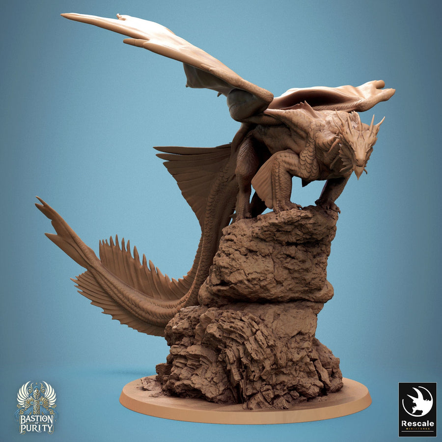 Bronze dragon miniature perched atop a craggy rock formation, detailed scales and wings visible