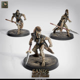 Three skeleton spearmen miniatures in combat stances with long spears