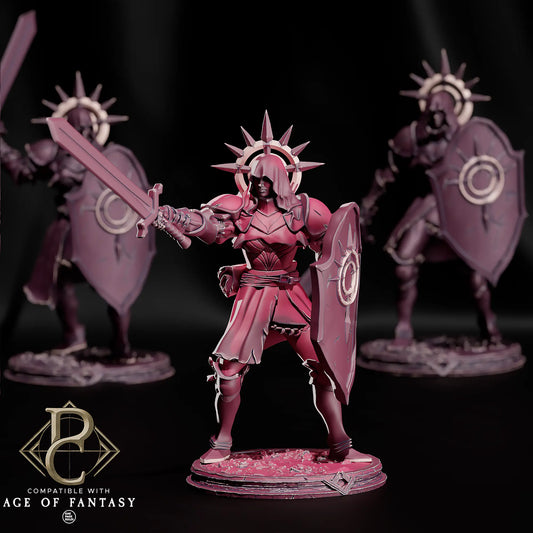 Frontansicht der Dawnshield Sister Schwertkämpferin mit Schwert und Schild, im Hintergrund zwei weitere unscharfe Miniaturen