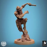 Side profile of a ghoul fighter miniature in a mid-air strike pose with sword