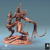 Tree monster miniature, back-right angle, detailed bark texture and wooden blade.