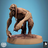 Crouching ghoul figure with shoulder spikes, wielding a bone club, front view.