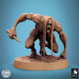 Ghoul miniature in a low, prowling stance with long hair and a bone weapon.