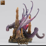 Front-left view of the deep dragon figurine, emphasizing the scale of the wings against the stalagmite terrain.