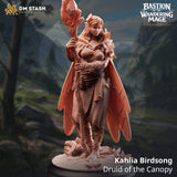 3D-printed Kahlia Birdsong Druid miniature standing on a nature base with a staff, forest background