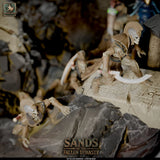 Close-up of skeleton warrior miniatures climbing the rocky base with ornate shields and curved blades.