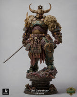 Full-body view of the Oni Colossus monster miniature standing on a skull-covered pedestal against a light background.
