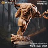 3D-printed Nordic War Chief miniature holding a double-headed axe with fur cloak detail on a scenic forest log base