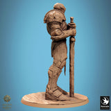 Side profile of the stone-textured fighter miniature standing in an armored, alert pose