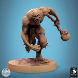 Ghoul miniature holding a skull on a spine, standing in an aggressive, upright pose.