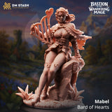 3D-printed resin miniature of a female bard named Mabel sitting on a rock playing a heart-shaped harp