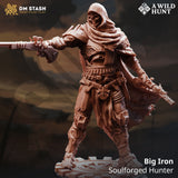 A 3D-printed resin gunslinger miniature with a hood, mask, and dual pistols standing on a mechanical gear base.
