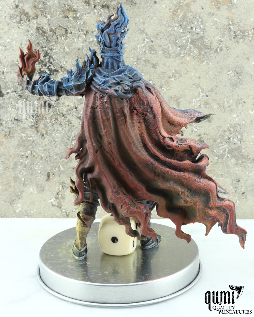 back view 2 Fantasy figurine with a sword and glowing blue hair on a metallic base with a die, against a textured gray background.