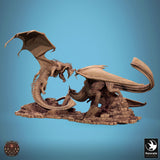 Side profile of two dragons in a combat diorama on a ruined stone base.