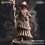A 3D-printed human female mage miniature named Alia holding a staff and wearing a wide-brimmed hat