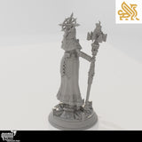 Rear view of a female cleric figure in hooded robes holding a tall staff on a detailed circular base.