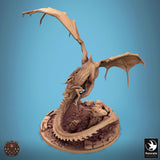 High angle view of the dragon miniature soaring above a rocky, textured circular base.
