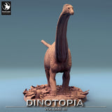 Front view of the Diplodocus miniature standing on a detailed base with pottery and debris.