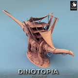 High angle view of a 3D-printed dinosaur miniature with a detailed cargo caravan, showing the wooden deck structure.