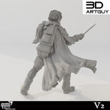 Rear view of the miniature showing a detailed backpack, flowing cloak, and textured fabric gear.
