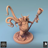 High angle shot of the monster miniature wielding a bell-adorned staff, showcasing detailed textures.