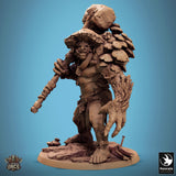 Angled view of the resin troll miniature standing on a rocky base, emphasizing the fungal armor texture.