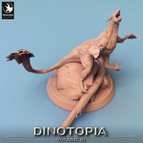 Top-down isometric view of the Pyroraptor dinosaur miniature on its circular rock and log base.