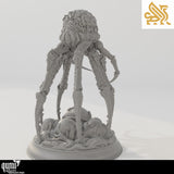 Gray resin render of a tall, multi-legged alien creature standing over a cluster of organic, brain-like eggs.