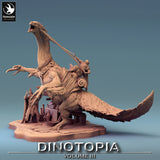 Side profile of a feathered Therizinosaurus dinosaur model featuring a rider and merchant