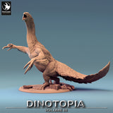 Full view of the standing Therizinosaurus miniature with long claws and feathered texture.