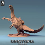 Side profile of a feathered Therizinosaurus miniature with saddle and gear on a base.