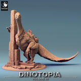 Front view of a feathered therizinosaurus miniature leaning against a crumbling stone pillar.