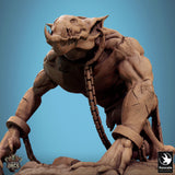 Low angle view of the troll miniature featuring sharp tusks, scarred skin, and iron wrist shackles.