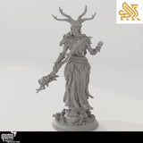 Rear view of the druid miniature showing braided hair, antler headpiece, and textured robes.