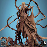 Close-up of the banshee miniature highlighting the face hood, detailed corset, and gravestone base texture.