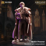 Resin 3D-printed wizard miniature Robin Presner standing on a candlelit base holding a spellbook and wand