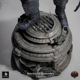 Close-up of miniature boots standing on a sewer grate base detailed with sculpted rats.