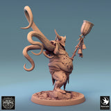 Side profile of the diseased executioner figure holding a staff decorated with hanging bells.