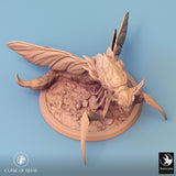 Side-angle shot of the insectoid miniature, showing its curved tail and legs.
