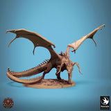 Front view of the dragon standing on a rocky terrain base with large curved horns and wings extended.