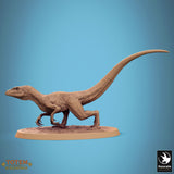 Side view of a raptor miniature on an oval display base.